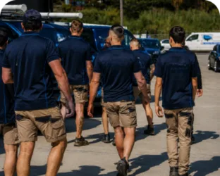Plumbers walking to their service vans on a Petersham job